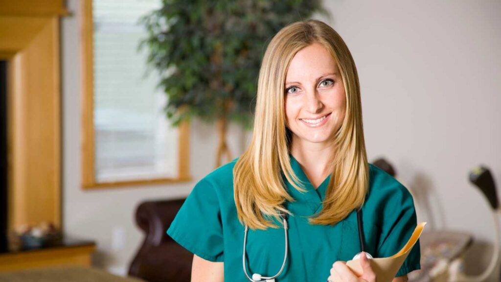 Nurse dressed in green holding a folder